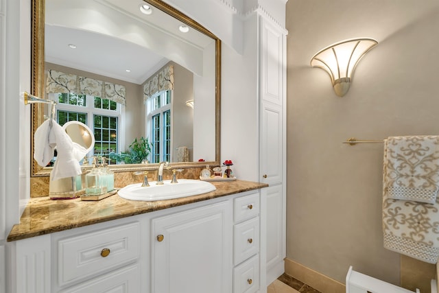 bathroom featuring crown molding and vanity