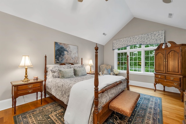 bedroom with lofted ceiling and light hardwood / wood-style flooring