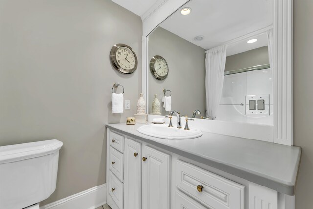 bathroom featuring vanity, toilet, and walk in shower