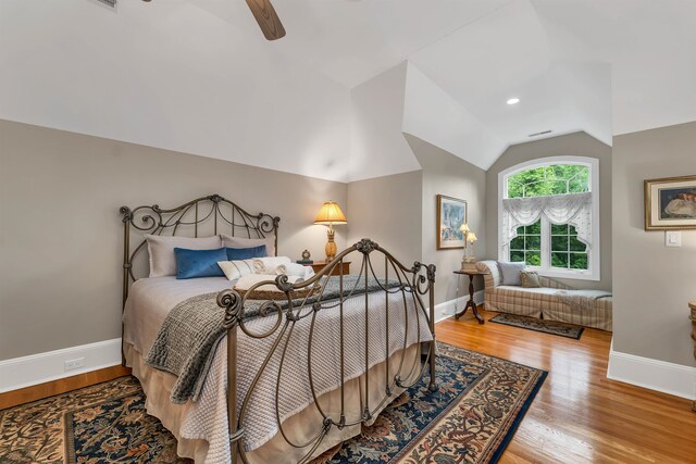 bedroom featuring vaulted ceiling, hardwood / wood-style floors, and ceiling fan