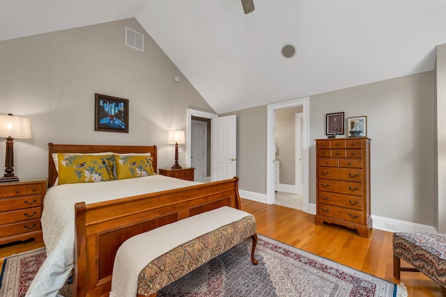 bedroom featuring light wood-type flooring, lofted ceiling, and ceiling fan