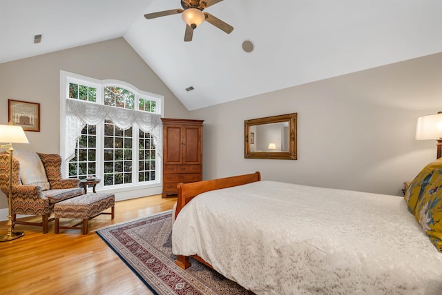 bedroom with lofted ceiling, light hardwood / wood-style flooring, and ceiling fan