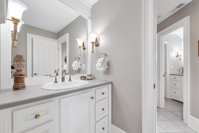 bathroom featuring tile patterned flooring and vanity