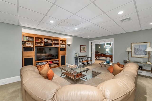 carpeted living room with a paneled ceiling and pool table