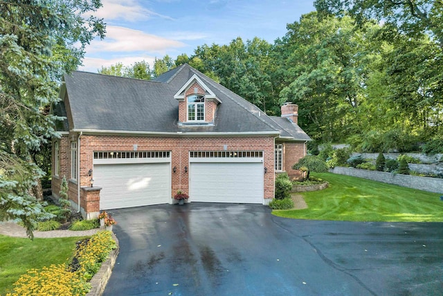 view of front of home with a garage and a front lawn