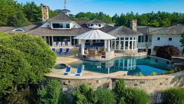 back of property featuring a bar and a patio area