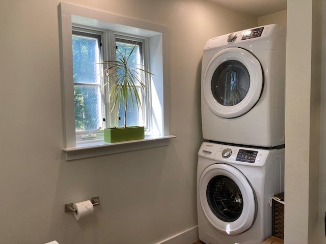 laundry area with stacked washer / drying machine