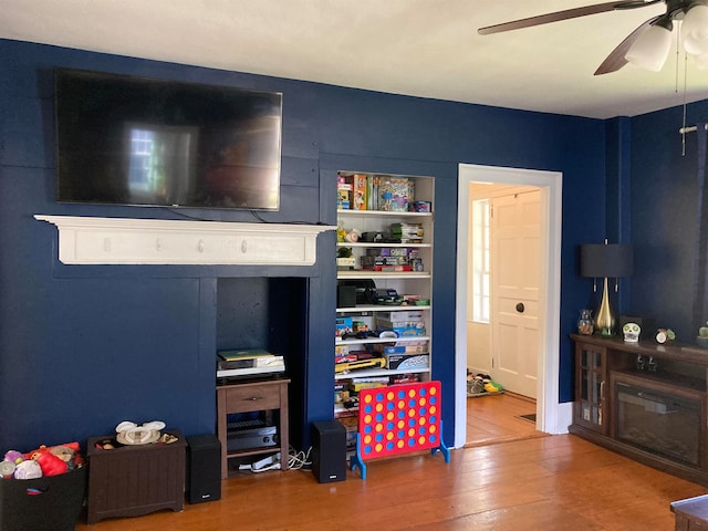 recreation room featuring wood-type flooring and ceiling fan