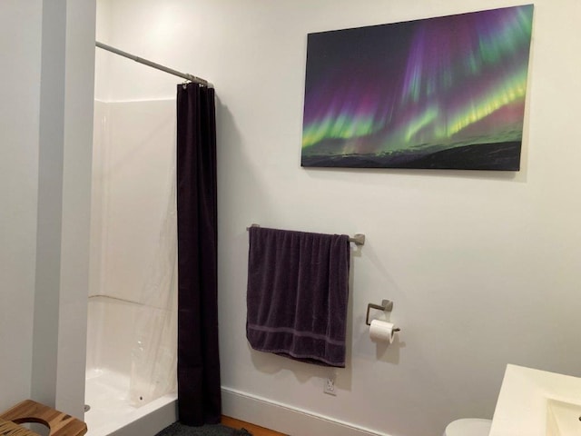 bathroom with toilet and curtained shower