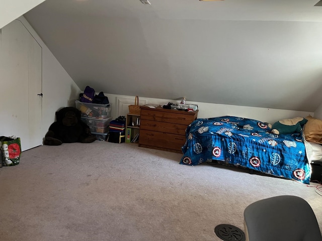 carpeted bedroom with vaulted ceiling