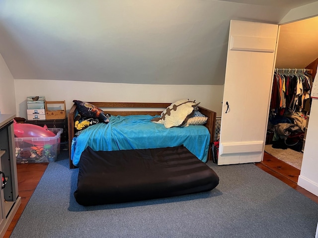 bedroom with vaulted ceiling and a closet