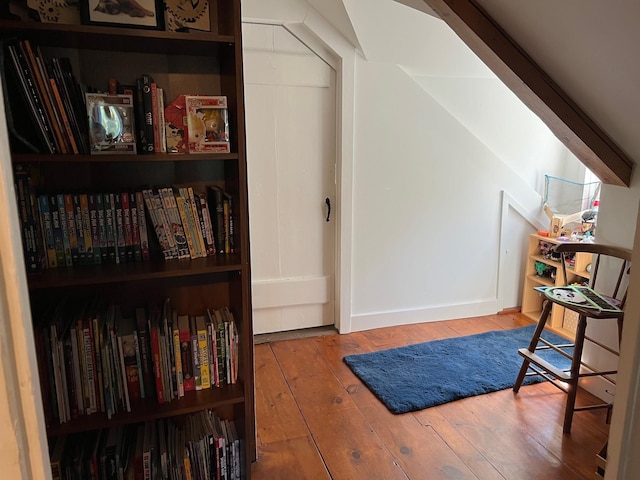 sitting room featuring light wood-type flooring and vaulted ceiling