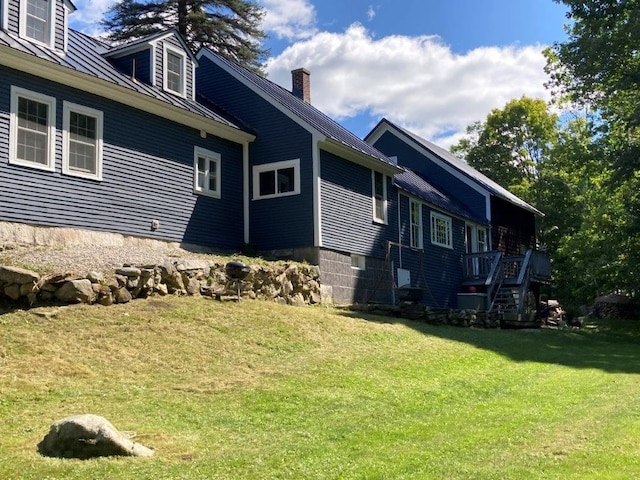 view of side of property with a lawn