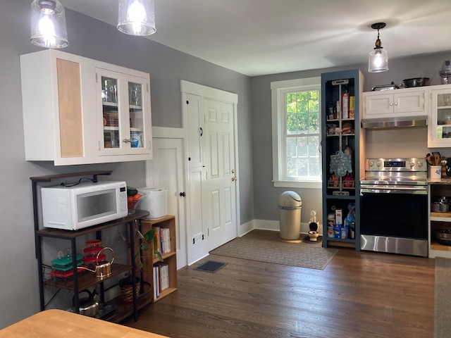 kitchen with dark wood-type flooring, decorative light fixtures, white cabinets, and stainless steel range with electric cooktop