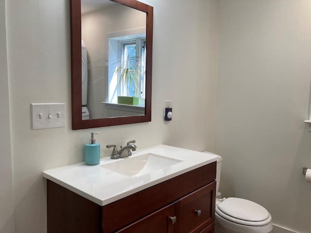 bathroom featuring vanity and toilet