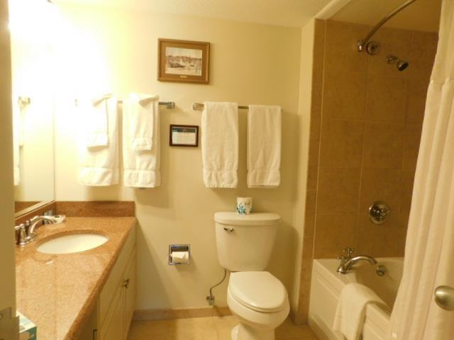 bathroom with baseboards, toilet, shower / tub combo with curtain, vanity, and tile patterned floors