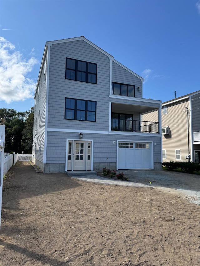 view of front of property featuring a balcony and a garage