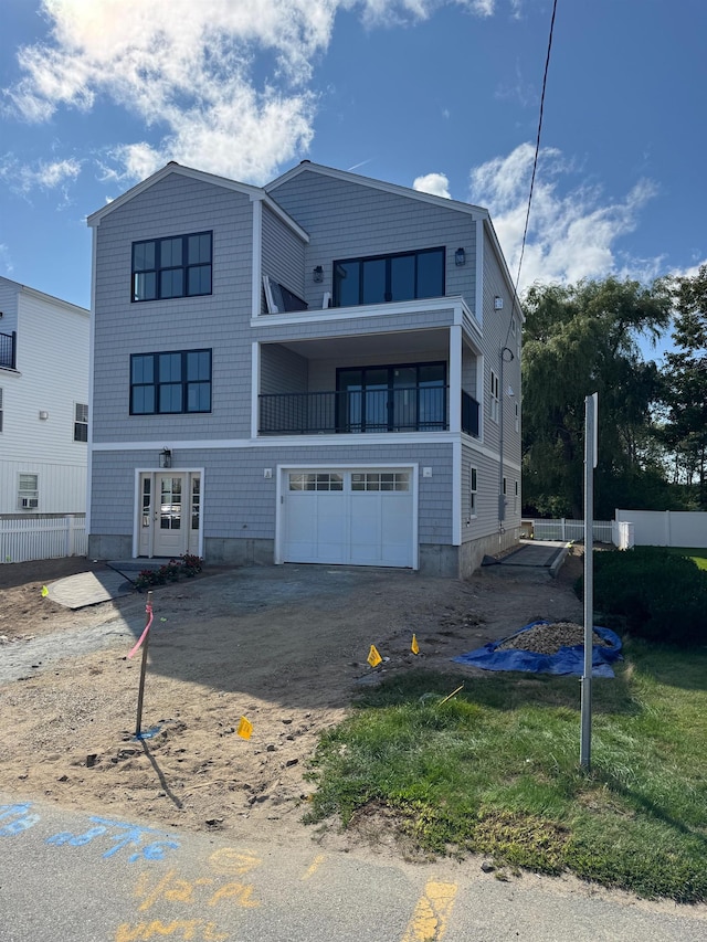 view of front facade with a balcony and a garage