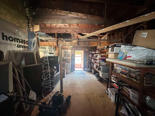 miscellaneous room with lofted ceiling and wood-type flooring