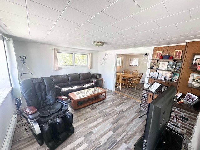 living room featuring light wood-type flooring and a baseboard radiator