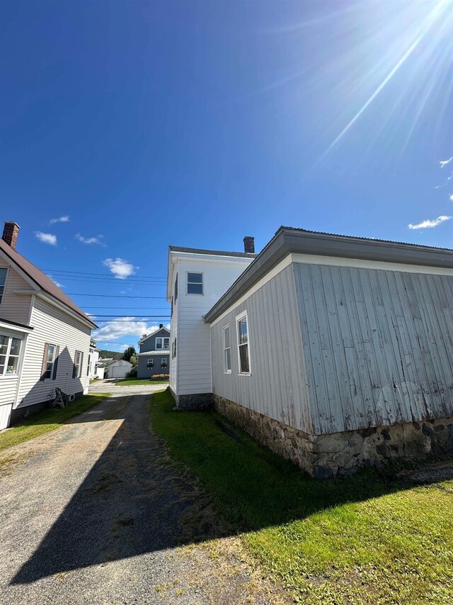 view of property exterior with a yard