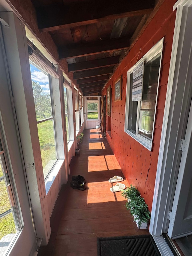 exterior space with wood ceiling, plenty of natural light, and beamed ceiling