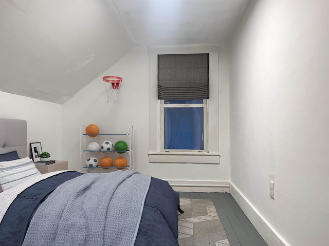 bedroom featuring vaulted ceiling and wood-type flooring