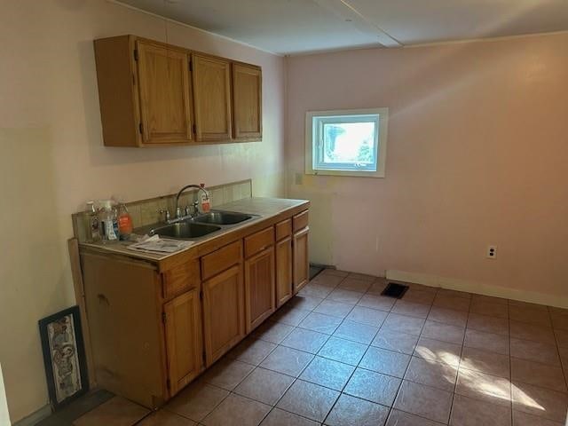 kitchen with light tile patterned flooring and sink