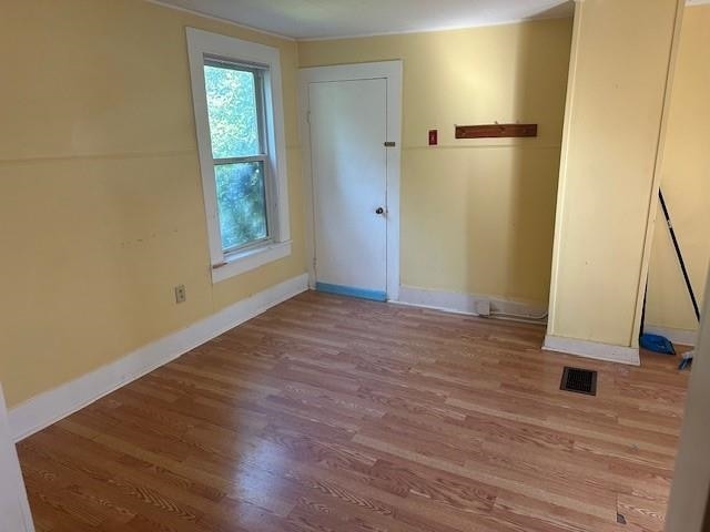 unfurnished room with wood-type flooring