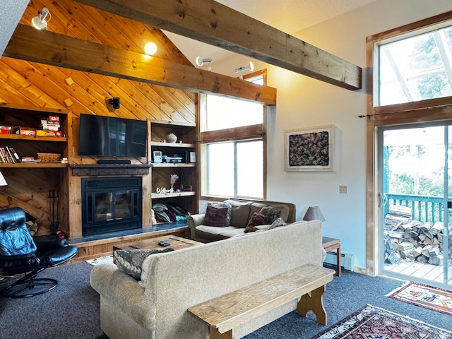 living room featuring a baseboard radiator, carpet, vaulted ceiling with beams, and built in shelves