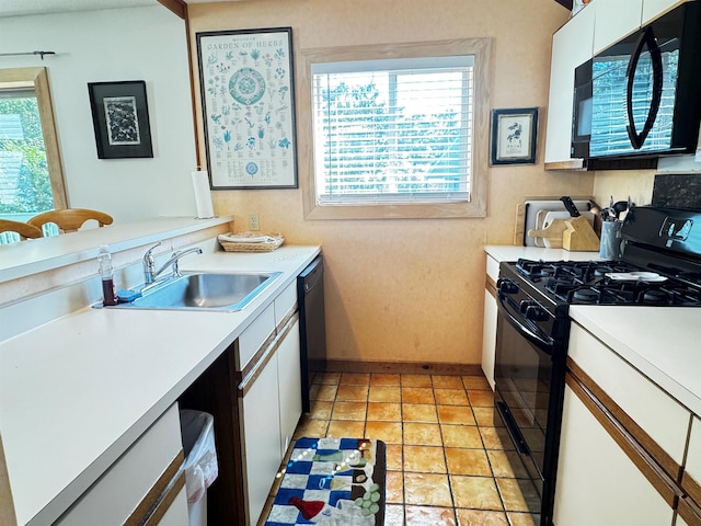 kitchen with white cabinets, light tile patterned floors, sink, and black appliances