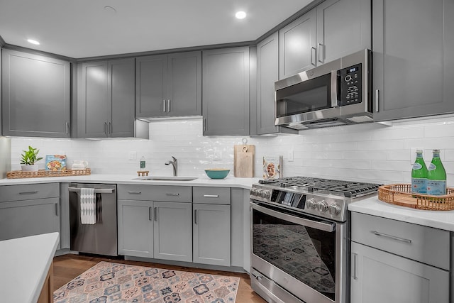 kitchen featuring gray cabinets, sink, and stainless steel appliances