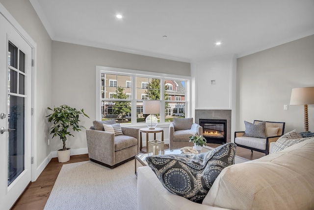 living room with ornamental molding and hardwood / wood-style flooring