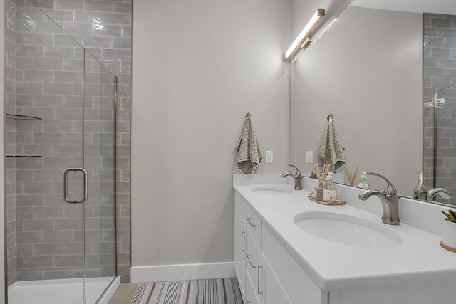 55 Pointe Pl # 106, Dover, NH 03820 - bathroom with a shower stall, double vanity, baseboards, and a sink
