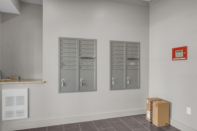 interior details with tile patterned flooring and a mail area