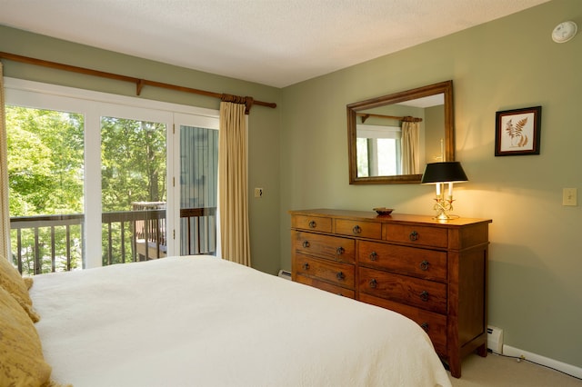 carpeted bedroom featuring a baseboard radiator, multiple windows, a textured ceiling, and access to exterior