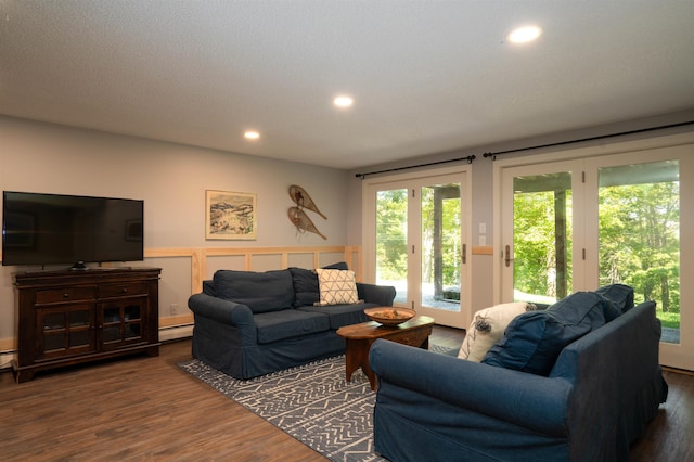 living room with a baseboard heating unit, french doors, and hardwood / wood-style flooring