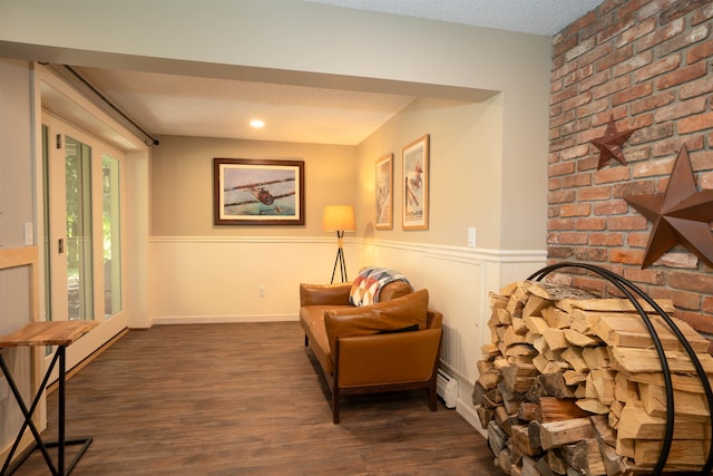 sitting room with a textured ceiling and dark hardwood / wood-style flooring