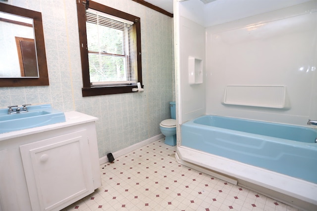 full bathroom with tile walls, separate shower and tub, toilet, and vanity