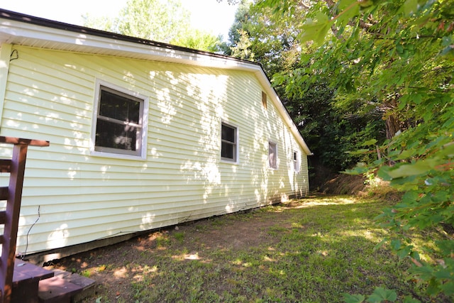 view of property exterior with a yard