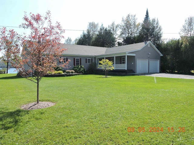 single story home with a garage and a front lawn