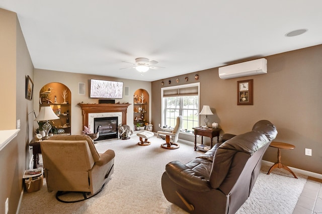 living room with a premium fireplace, baseboards, a ceiling fan, and a wall unit AC