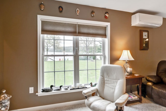 sitting room featuring carpet floors and an AC wall unit