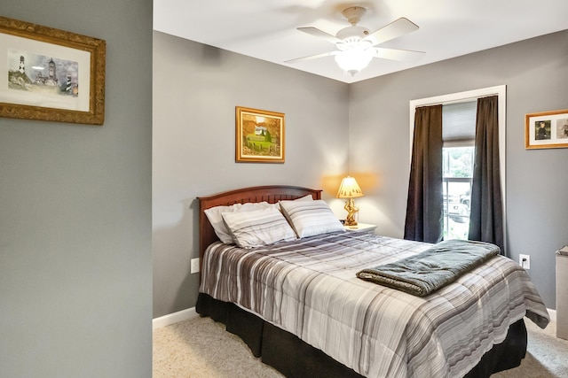 carpeted bedroom featuring a ceiling fan and baseboards