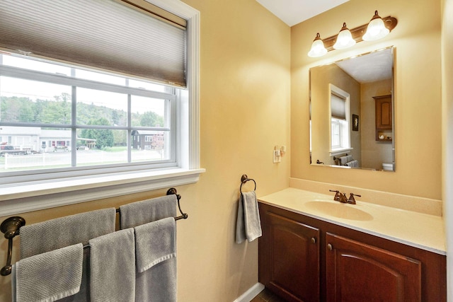 bathroom featuring a healthy amount of sunlight and vanity