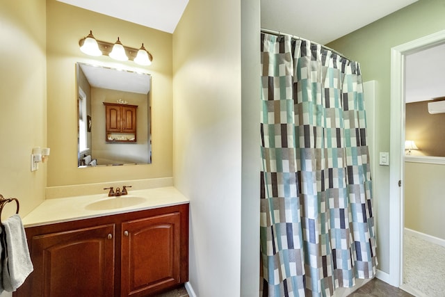 bathroom with vanity, a shower with curtain, and baseboards