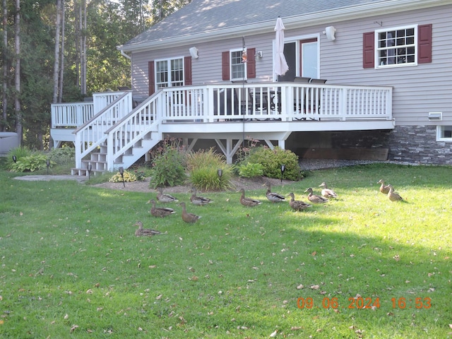 exterior space featuring a deck and a front lawn