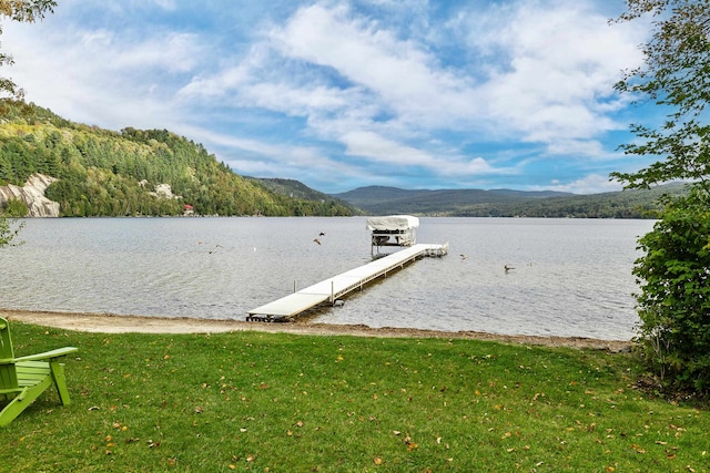 view of dock featuring a yard and a water and mountain view