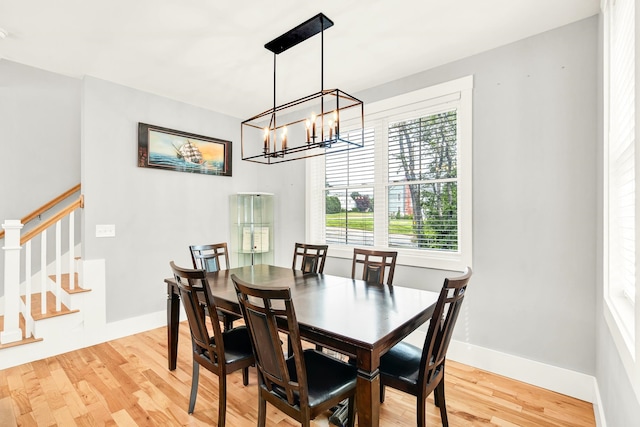 dining room featuring light hardwood / wood-style floors and a notable chandelier