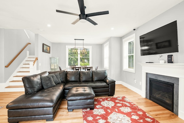 living room featuring light wood-type flooring and ceiling fan